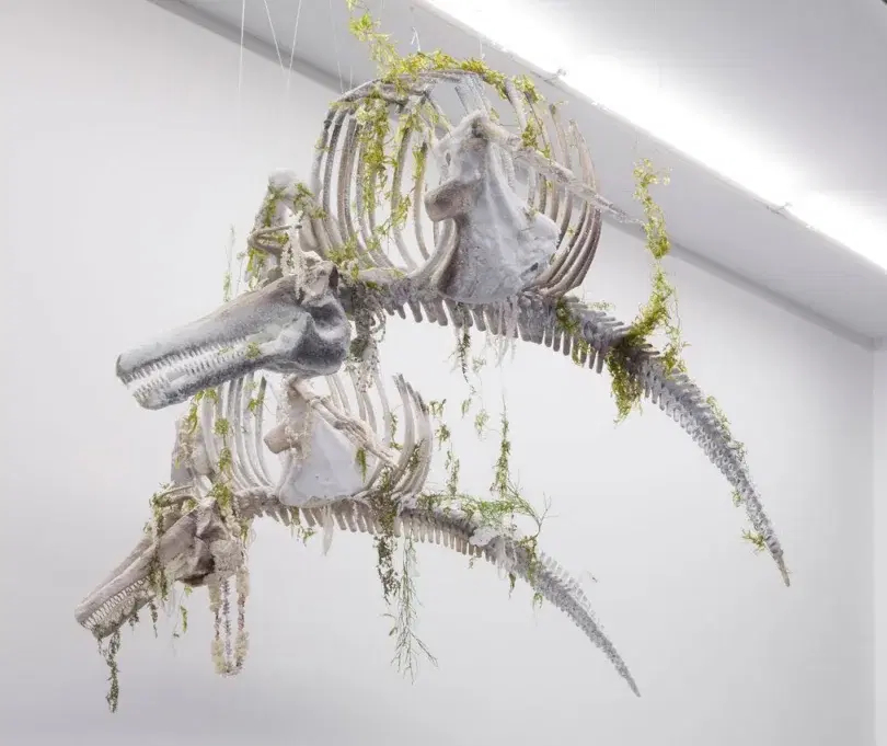 Bianca Bondi’s suspended dolphin sculpture with a crystallized beaded necklace and dried plants.