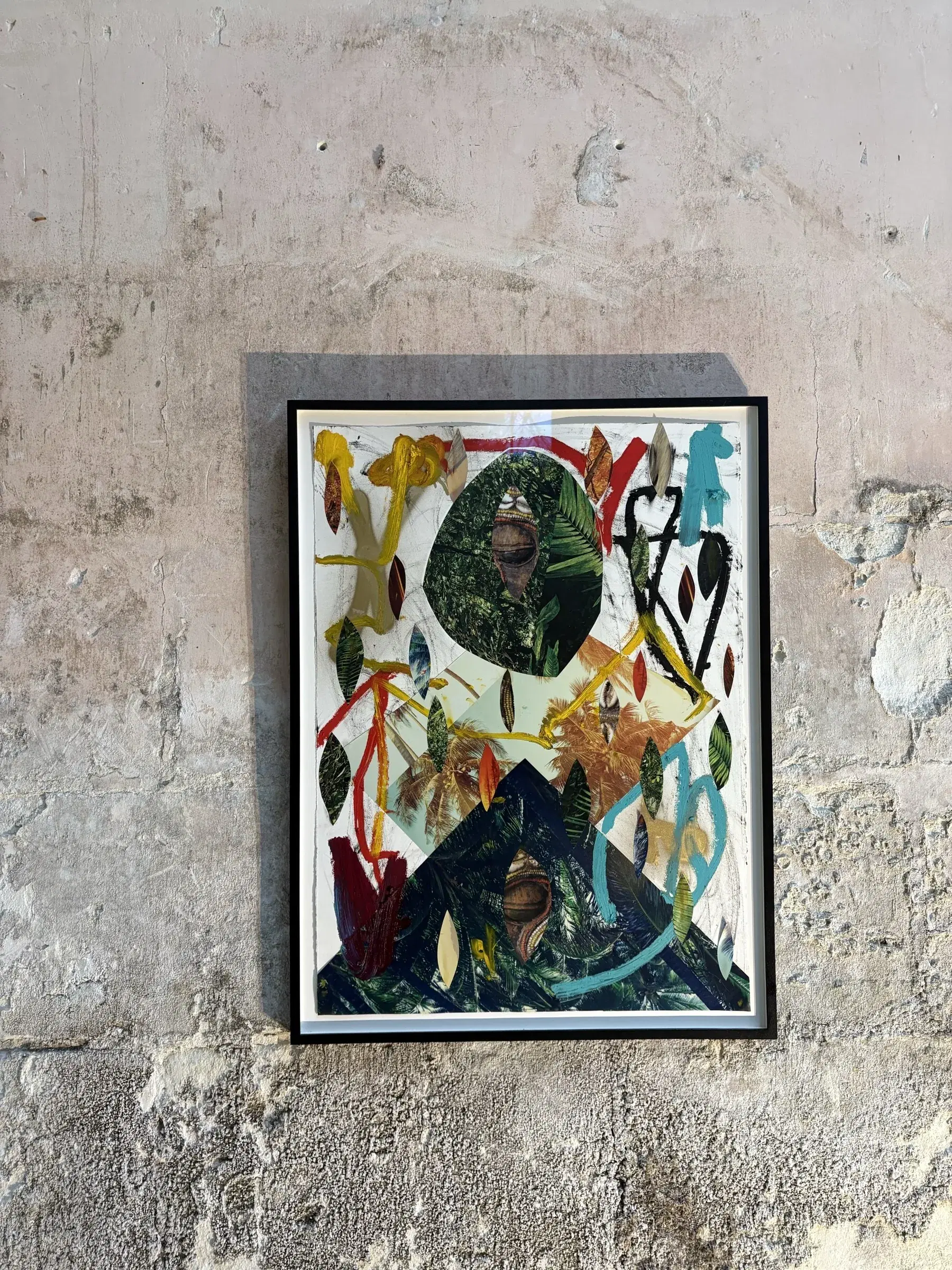 Framed mixed-media portrait surrounded by painted leaves, birds and organic forms.