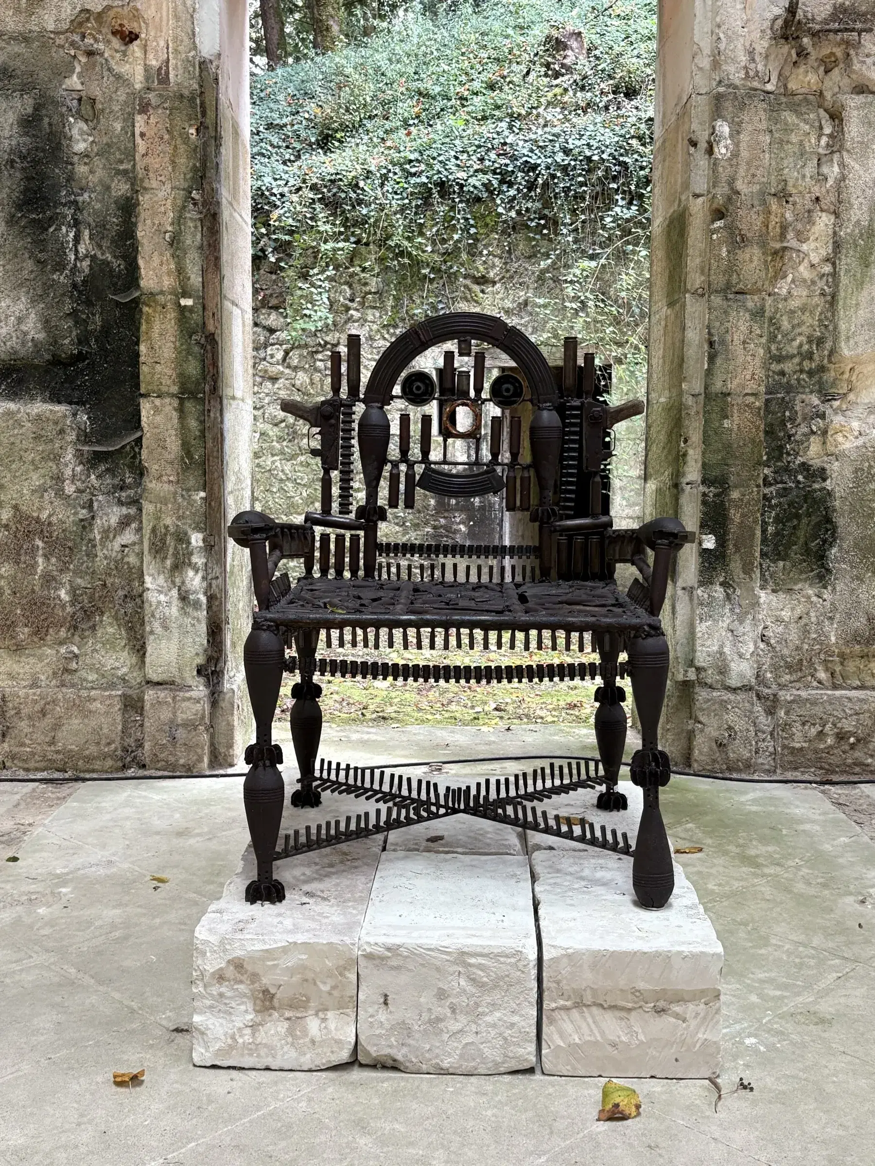 Gonçalo Mabunda’s throne made from decommissioned weapons, installed in a stone archway.