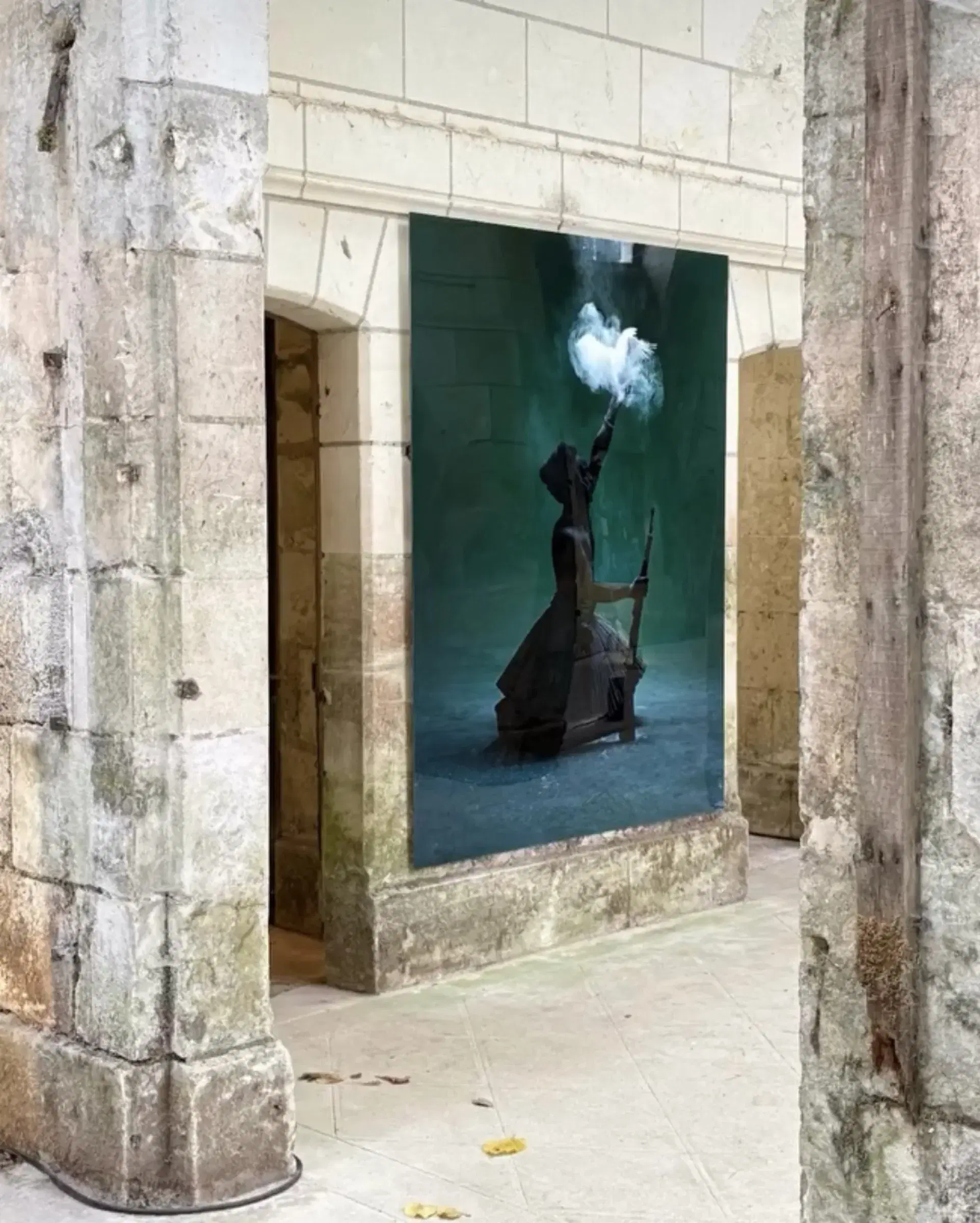 Mohau Modisakeng’s Ditaola XV installed within a stone doorway.