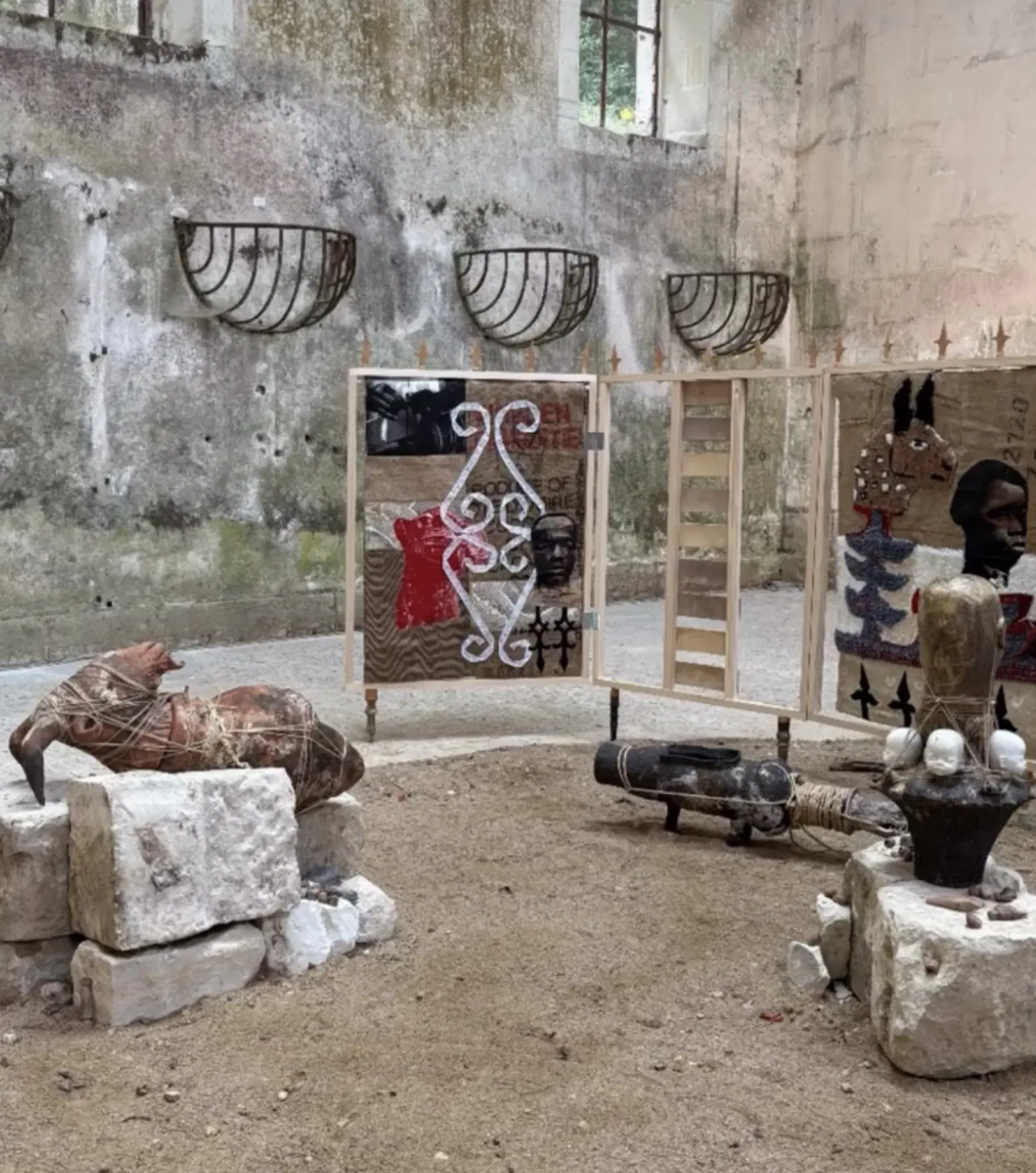 Installation view of the sculptural ensemble and freestanding panels in the stone interior.