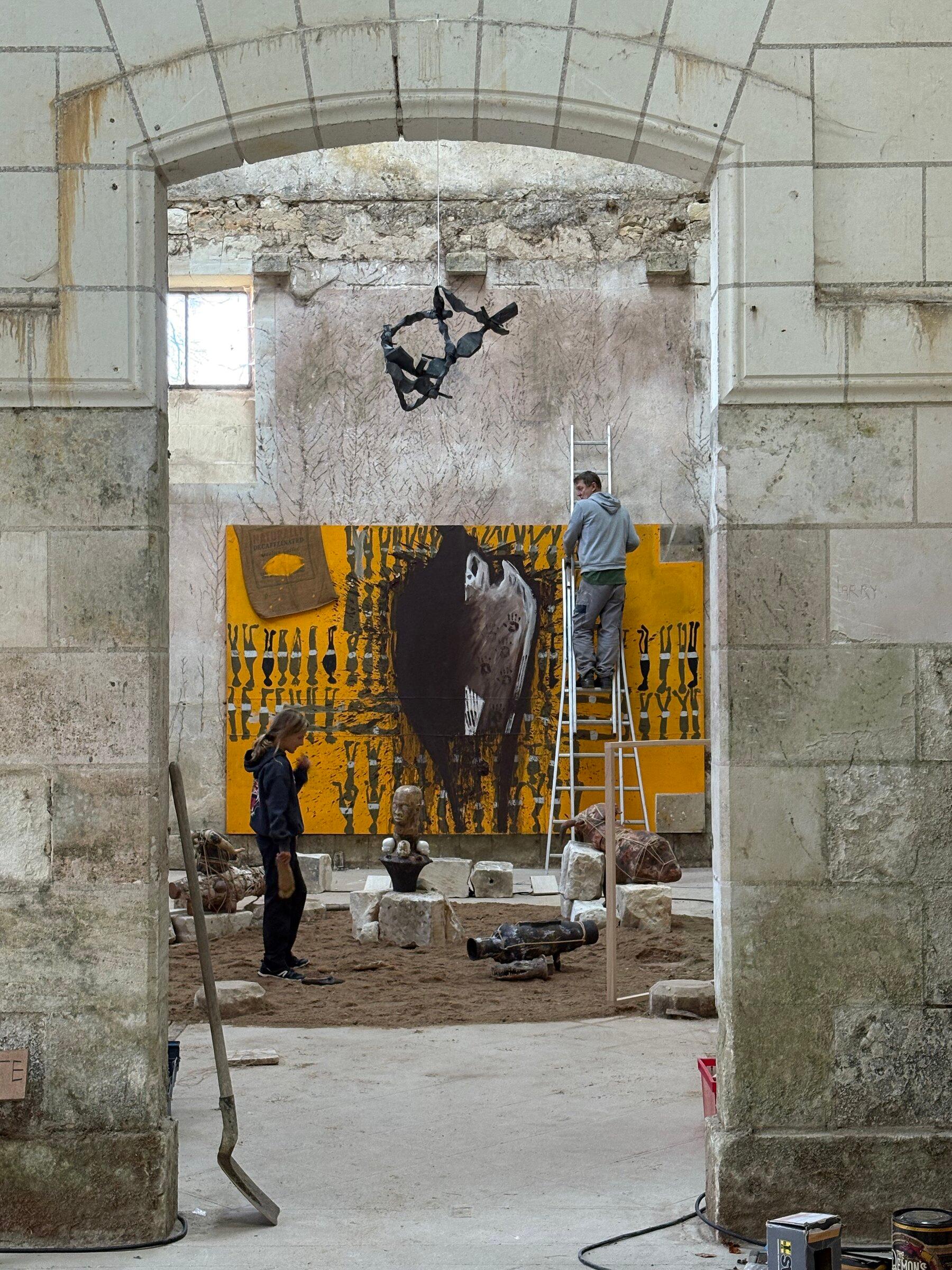 Contemporary African artworks installed inside the stone architecture of Château de Montgoger.