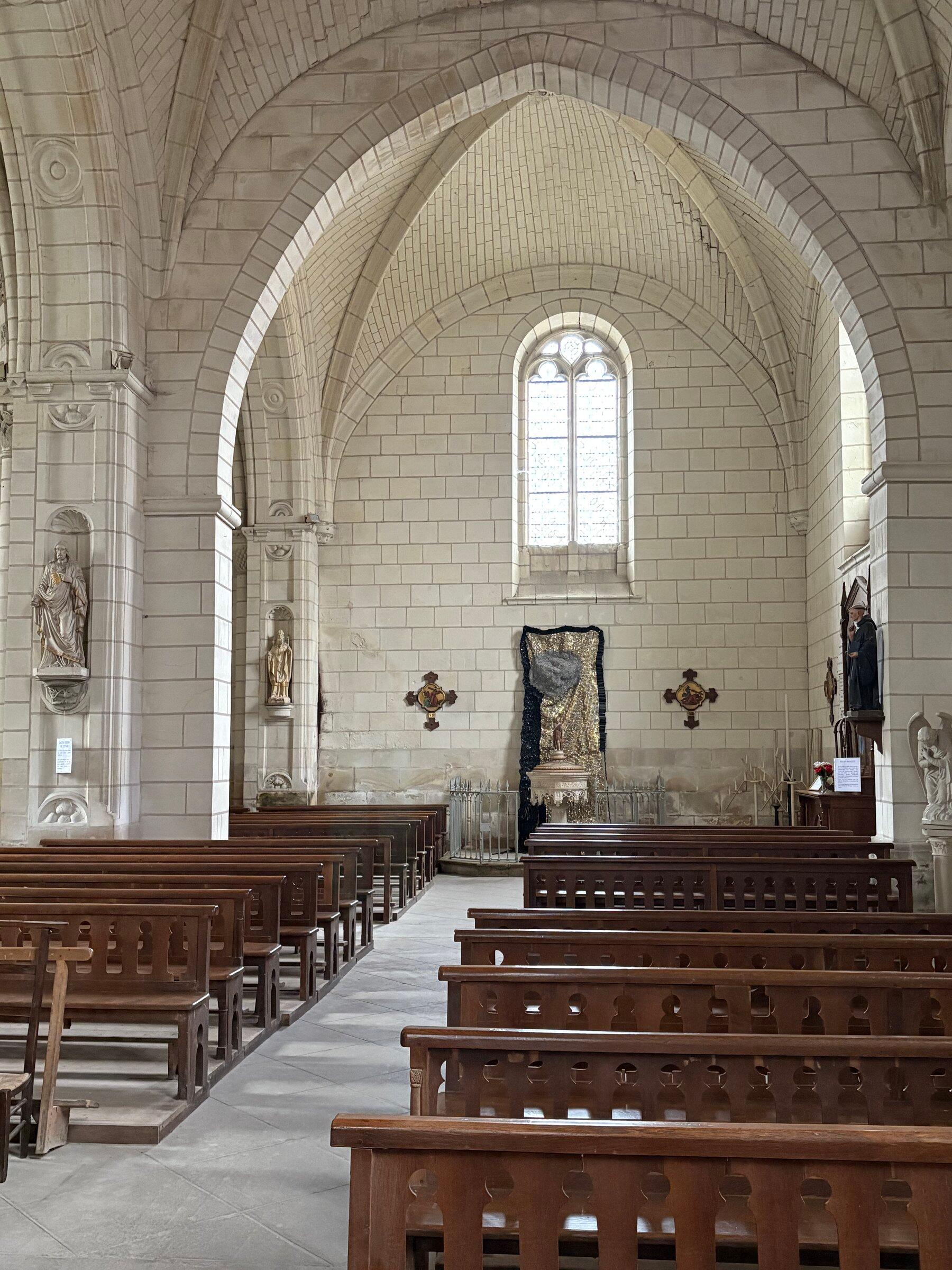 The chapel interior at Château de Montgoger with vaulted architecture and installed works.