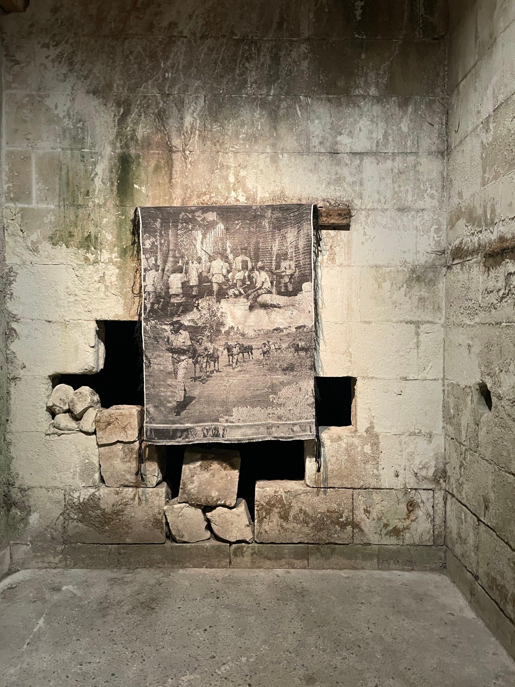 An artwork installed in a stone passage at Château de Montgoger.
